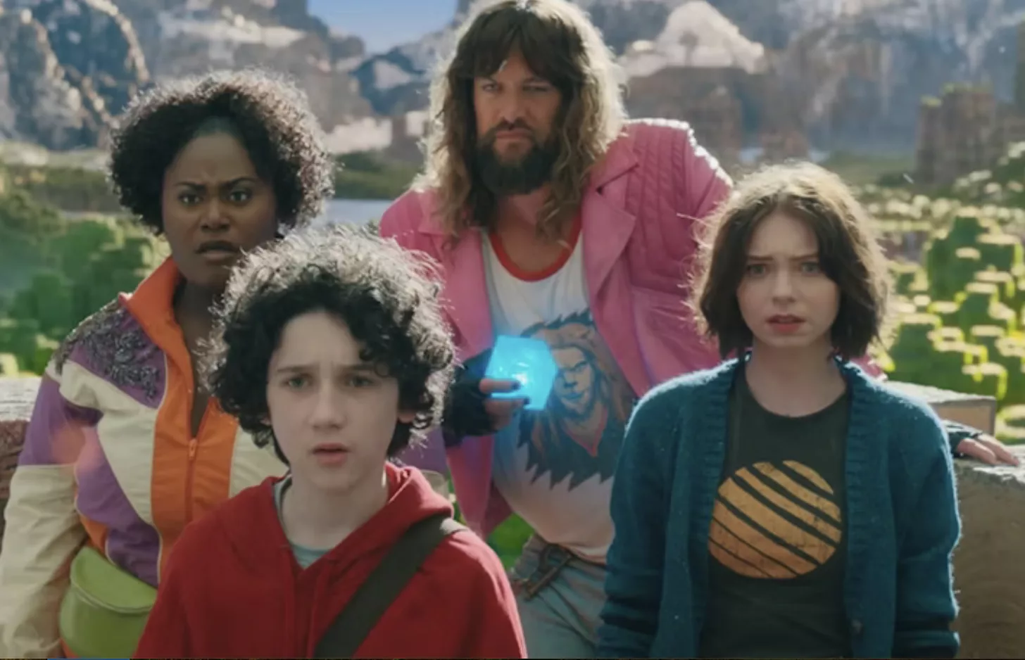 Rachel Brooks, Sebastian Hansen, Jason Momoa and Emma Meyers in A Minecraft Movie, pictured in the game's colorful, blocky universe